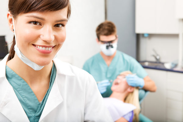 Pediatric dental assistant helping